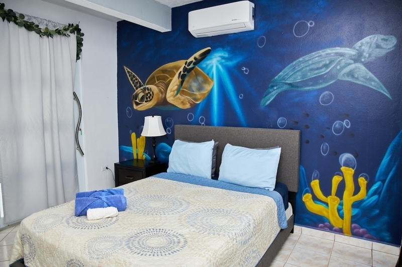Sleep surrounded by art that matters—one-of-a-kind mural & stunning ocean views right from your master suite. 🌊✨ 