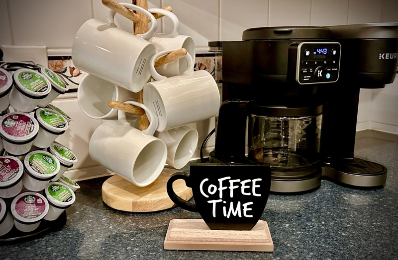 Coffee bar featuring Keurig, selection of coffee, hot chocolate, tea, creamers