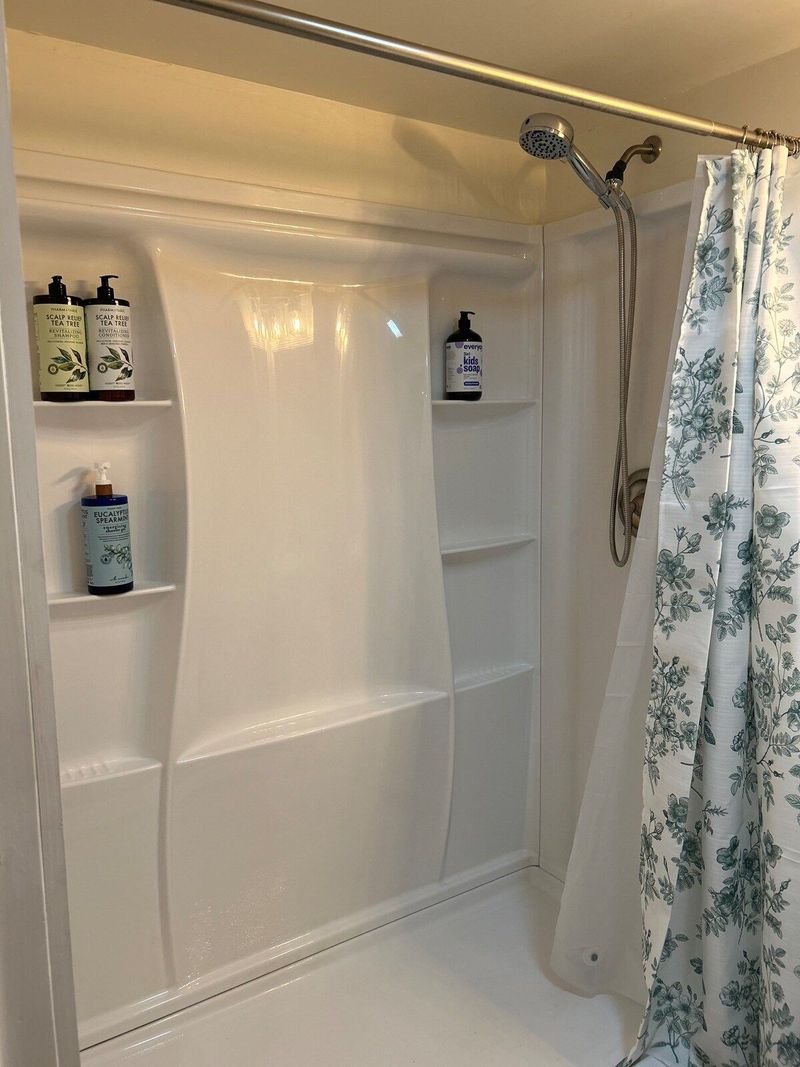 Freshen up after traveling in this fully stocked restroom with makeup cloths and towelettes, bath mats, hairdryer, plenty of fluffy towels and washcloths, eco friendly shampoo, conditioner, body wash and children’s 3-in-1 soap! Walk-in shower