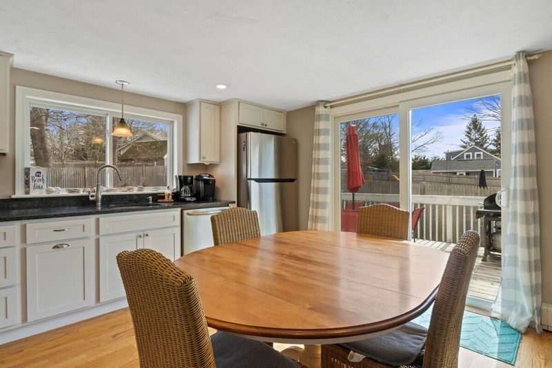 Easy access to large deck off kitchen with propane grill and outdoor dining