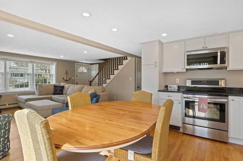 Dining table with extension leaf (additional folding chairs in closet, if needed)