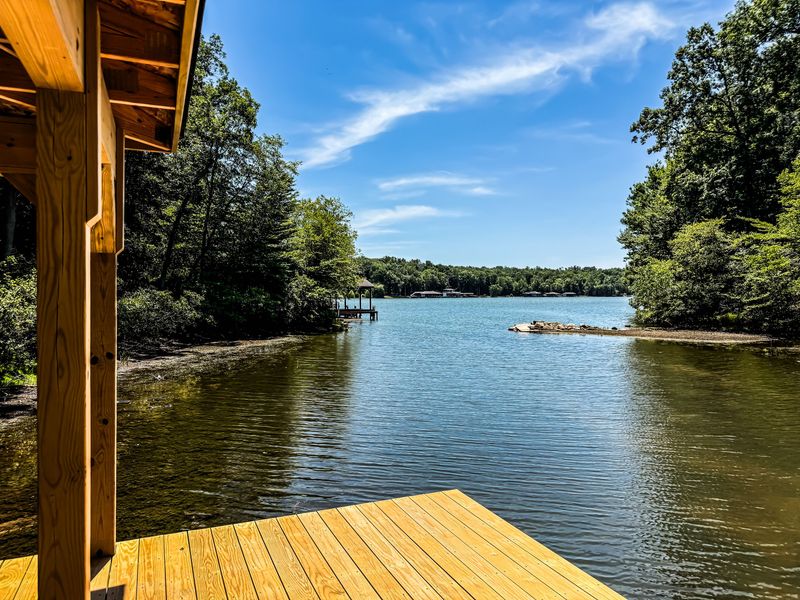 Private dock with serene lake views and peaceful wooded surroundings