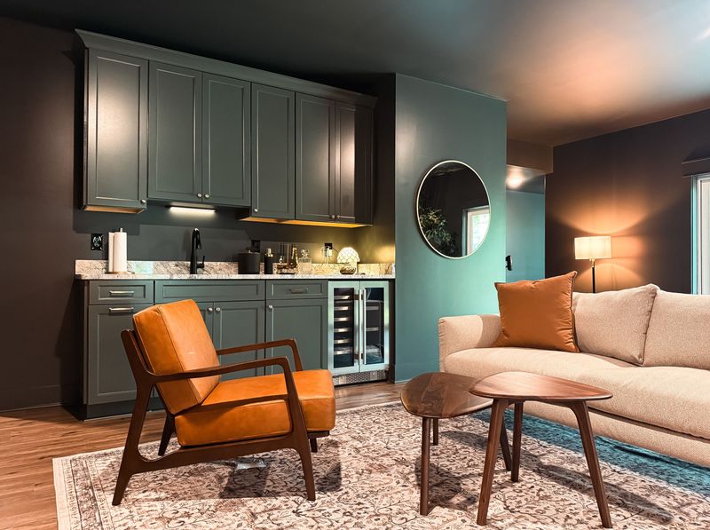 Cozy lounge with designer wet bar and stylish mid-century seating