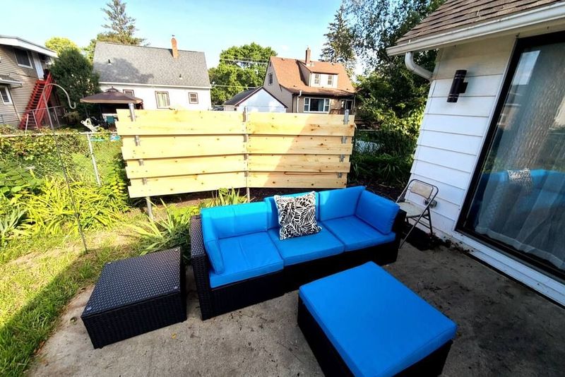 The patio features a nice shady spot to relax in the fenced in backyard