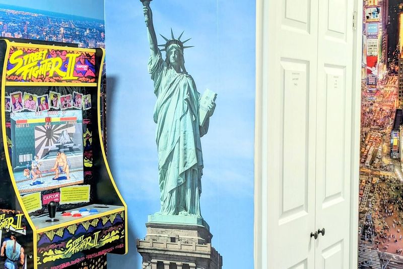 Street Fighter Arcade Game next to Lady Liberty