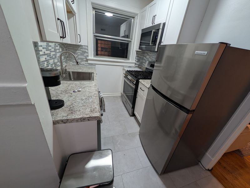 Bright modern kitchen with stainless appliances and stylish finishes