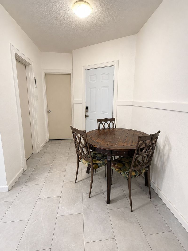 Cozy entryway dining nook with tile floors and seating for three