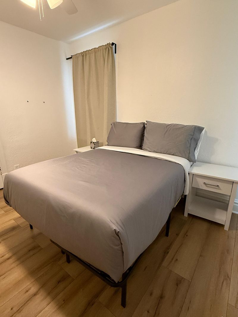 Clean, cozy bedroom with neutral decor and convenient bedside tables