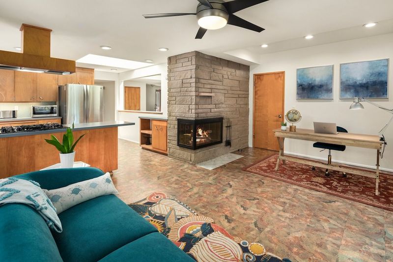 The second living room also features a gas fireplace and open access to the kitchen