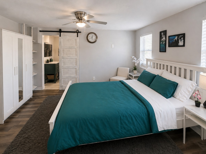 The primary bedroom includes a comfortable king bed and direct access to a private en-suite bathroom.