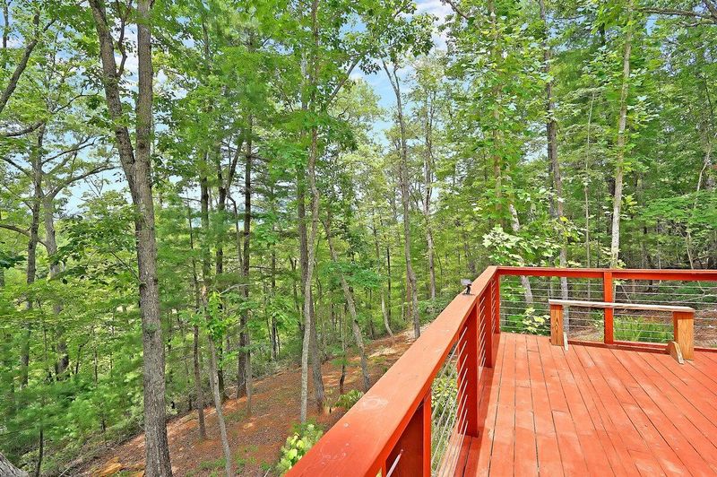 Huge deck with grill, lounge chairs, dining table and Bluetooth speaker