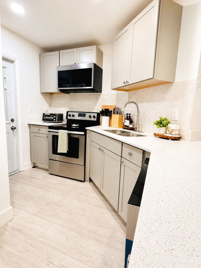 Kitchen with full-size appliances, cookware and dishes for meals during your stay.