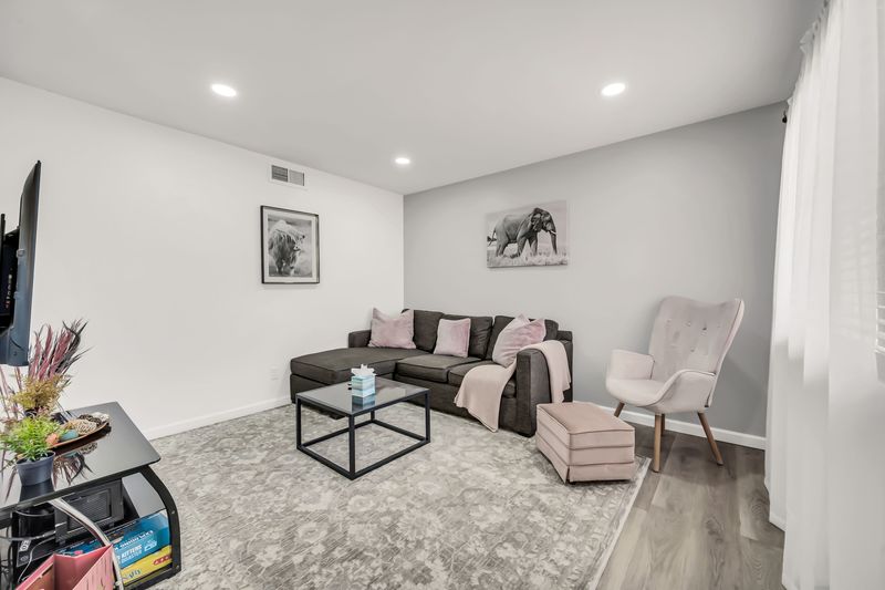 Bright, cozy living room with sectional, reading chair, and modern decor