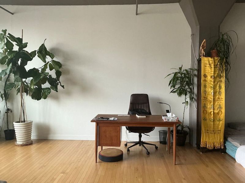 Minimalist workspace with a luxury leather office chair. Monitor, light, fast wifi