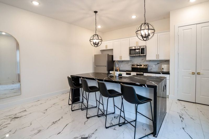 Spacious island with bar seating for easy dining and gathering.